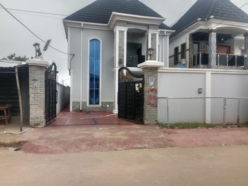 Completed duplex behind a decorative black gate