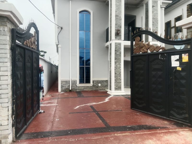Duplex entrance with grey stone cladding and an arched window