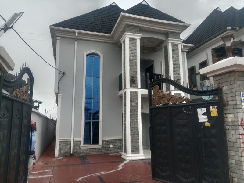 Grey and white duplex with stone-clad columns