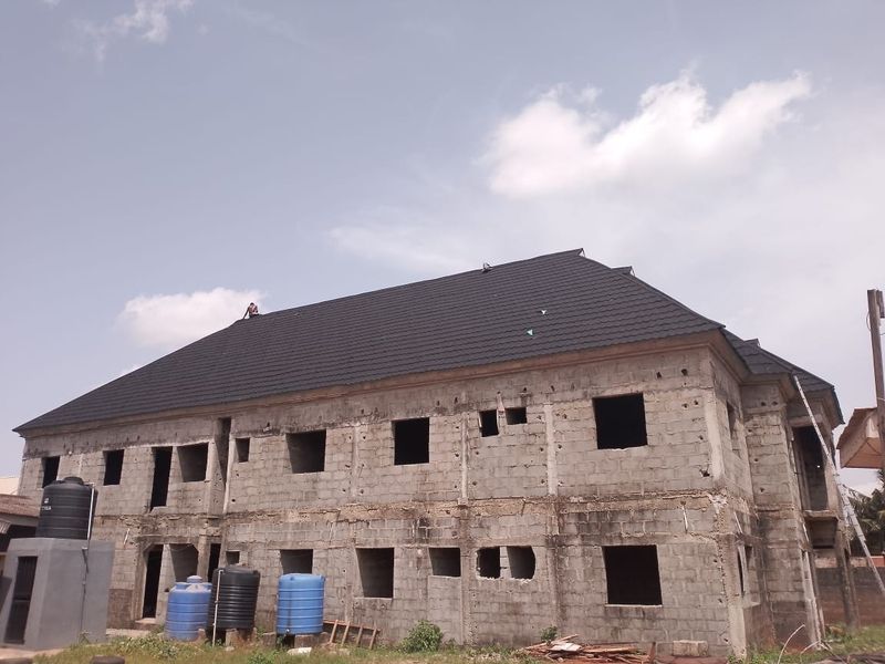 Side view of a roofed blockwork building awaiting plaster