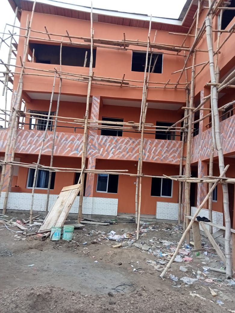 Rendered three-storey building wrapped in scaffolding